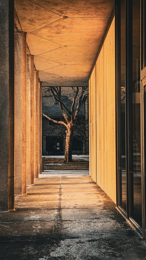 Sunlit corridor capturing modern Detroit architectural elements during golden hour.
